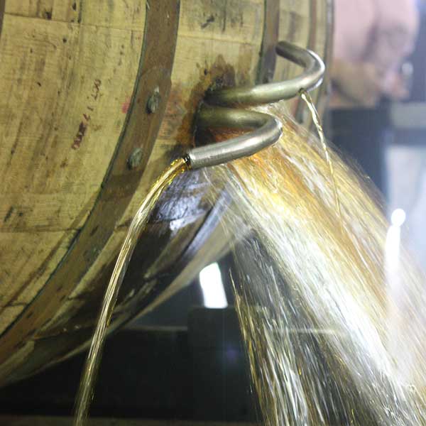 Bourbon pouring out of barrel